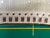 Strip of taped amber ceramic capacitors in a bag over a green gridded mat