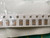 Strip of tan chip capacitors in paper tape, angled inside a clear bag