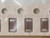 Three chip capacitors with oval silver end terminations seated in white paper tape
