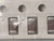 Three dark brown chip capacitors in tape, bag film crumpled over the left one