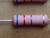 Close view of pink-bodied axial resistor banded blue, red, brown and gold
