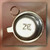 Top of the TO-72 can showing stamped ZE, a side tab, and copper-colored wire loop