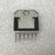 Reverse of the LM2416T showing bright metal mounting tab, bolt hole and eleven staggered leads