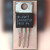 National Semiconductor LM340T-12 TO-220 regulator held in hand, body marked LM340T12 7812 P+
