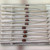 Rows of axial chokes held in white paper tape strips, leads bent