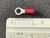Red-insulated ring terminal, approximately 3/4 inch length confirmed by ruler. Silver barrel visible, closed-barrel style.