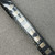 Cut strip of black carrier tape holding gold-colored surface mount PolySwitch fuses on light speckled surface