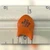 Macro of orange bullet-shaped Sprague disc capacitor stamped 3D N220 1KV on a white rule