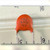 Macro of orange disc capacitor stamped 10J NPO 1KV against a white rule