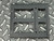 Underside view of the bracket showing rib grooves, cutouts, and drive tab holes
