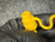 Gloved hand holding HFB boot with molded 30A rating and flexible S-shaped tether