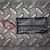 Black plastic body molded with 3.7V, UM-18650X2, SIZE 18650 OR EQUIV markings. Two spring contacts visible. Red and black wire leads attached.