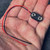 9V battery snap connector with red and black wire leads held in hand.