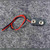 Top view of 9V battery snap connector showing terminals and wire leads.