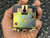 Rear of PM-17DY-24 showing gold chromate mounting bracket and keyhole slot, held in hand