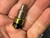 Cole Hersee 8706 push button switch held in hand, side view showing threaded bushing and plunger