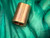 Unused copper oval sleeve, uniform warm tone, no tarnish or surface oxidation. Both bores clean and unobstructed. No deformation or seam separation visible.
