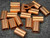 Approximately 20 unused copper oval sleeves; bright copper finish with no tarnish, oxidation, or deformation. Dual bores visible and open.
