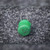 Top view of green radial lead inductor showing marking 24.