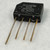 Black molded SIP-4 body marked TAIWAN, 9003, 2KBP02M, GI, 3N255; + and - polarity symbols visible. Four leads show light oxidation.
