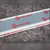 Close-up of repeating red Velcro wordmark printed on the adhesive strip release liner