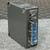 Angled view of EWS15-12 power supply showing painted side panel and corner mounting flanges