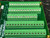 Overhead view of five green terminal strips with slotted screws and wire openings