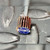 Close-up of the abrasive flaps and label on a Merit 08834137472 mini flap wheel.