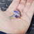 Merit 08834137602 flap wheel held in palm, showing face label with 120 grit and 25,000 max RPM rating.