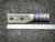 Lug on gray felt above steel ruler, barrel band and marks visible