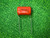 Sprague 225P Orange Drop capacitor marked .56 10 percent 100 DC on green cloth