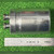 CG42U100A1 capacitor lying beside inch ruler, body about 2-3/8 inches long