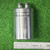 CG42U100A1 capacitor lying flat above inch ruler, can about 1-1/2 inches in diameter