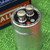 Top view of CG42U100A1 terminal end: two screw turrets, red positive dot, vent disc