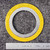 Flexitallic 1-1/4 inch spiral wound gasket top face beside inch ruler, yellow outer ring