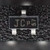 Black SOT-23 diode on a dark textured backdrop, top face marked JC with smaller p57