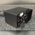 Rear three-quarter view showing heatsink, IEC inlet, spec label and coiled output lead