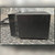 End view of charger showing aluminum heatsink fins and wrinkle-finish metal case