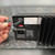 Close-up of rear label: POWER-SONIC PSC-124000AP, OUTPUT 12Vdc 4A, P/N 130-0019-01