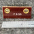 Close view of white F 3.55 marking on brown laminate base between two brass eyelets