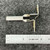 Square D AR-2.71 heater element angled, showing white ribbed coil and two brass-contact mounting brackets, ruler below.