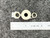 Top view of tan spool heater element with two eyelet terminals beside ruler.