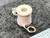 Close view of spool top and hollow center bore with brass eyelet terminal.