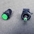 Green lens and bezel unit beside the indicator body with the green 28V LED lamp seated in its socket