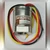 SenSym ST2P15G1 pressure sensor with red, black, and yellow lead wires coiled around housing.