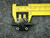A World Magnetics pressure switch PSF100A from PartsMine.com, shown alongside a yellow caliper for scale, with clear details of its labeling and fittings.