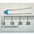 Blue ceramic disc capacitor printed 221 1KV with long straight leads beside millimetre ruler