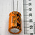 Upright Sprague 1000uF 35V capacitor showing cross-scored vent disc and long leads