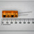 Sprague 513D 1500uF 35V electrolytic capacitor measured horizontally against a millimeter ruler.