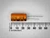 Sprague 513D 470uF 35V orange electrolytic capacitor lying beside a millimeter rule